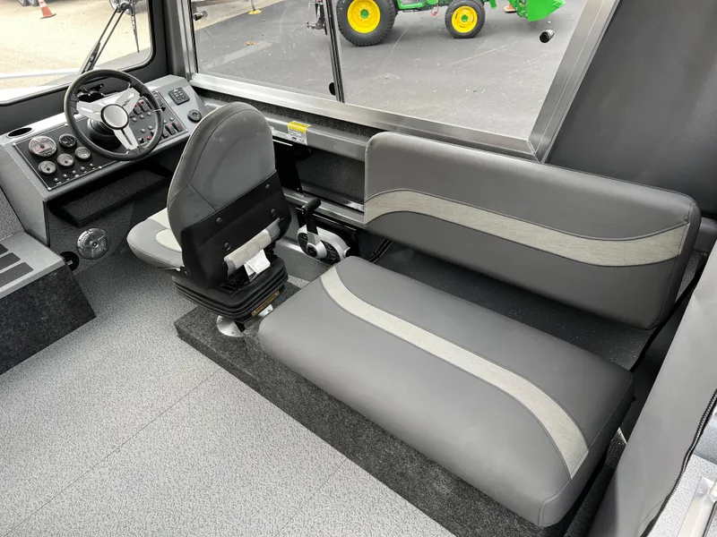 Slide: The Image of 2024 Spartan 215 Athens boat interior with steering wheel and seating. - 5