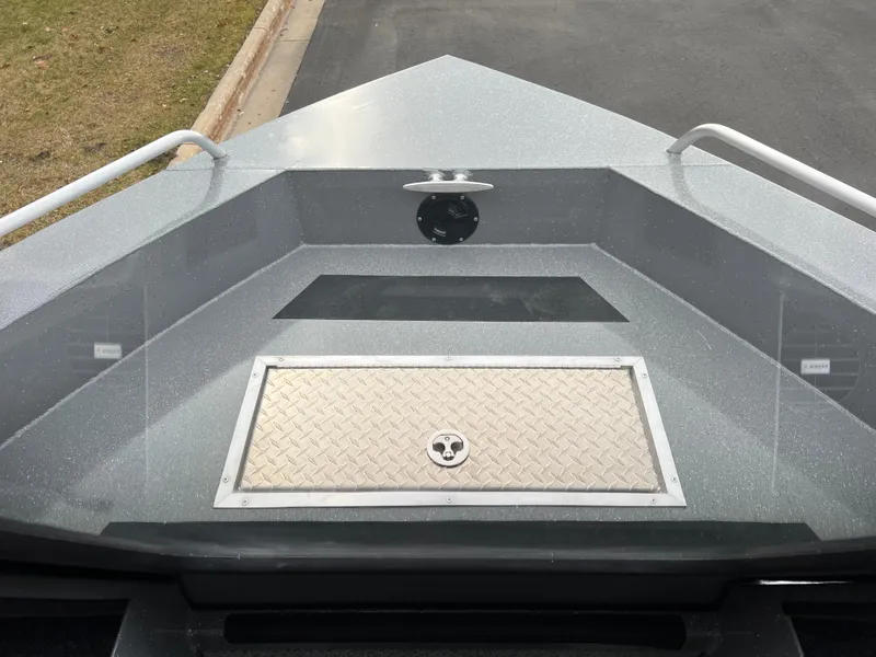 Slide: The Image of 2024 Spartan 215 Athens boat bow with storage compartment and handrails. - 9