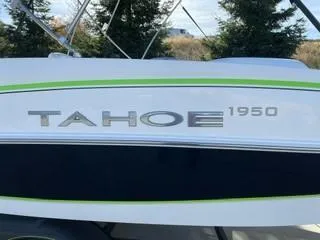 Slide: The Image of 2024 Tahoe 1950 boat with green stripe, side view. - 3