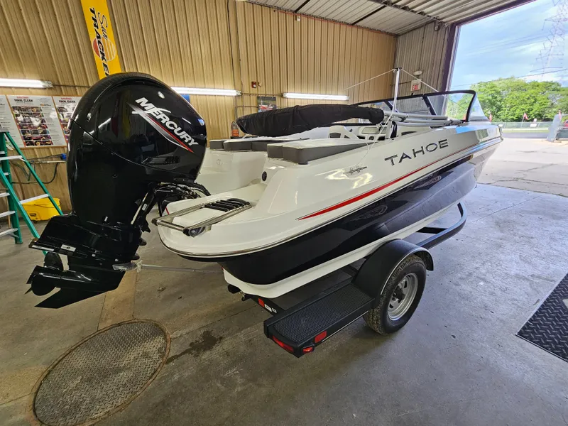 Slide: The Image of 2024 Tahoe 185 S boat with Mercury outboard motor in a garage. - 0