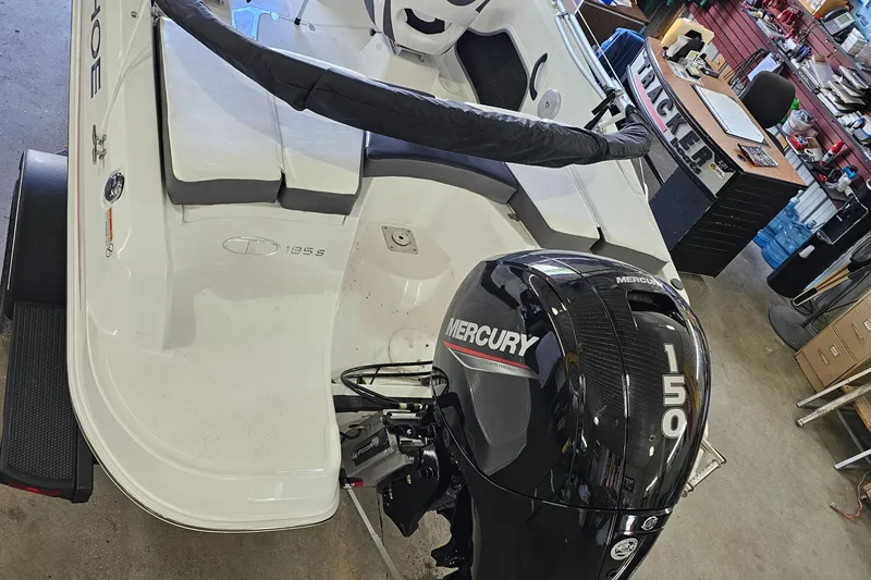 Slide: The Image of 2024 Tahoe 185 S boat with Mercury 150 outboard motor in a workshop. - 1