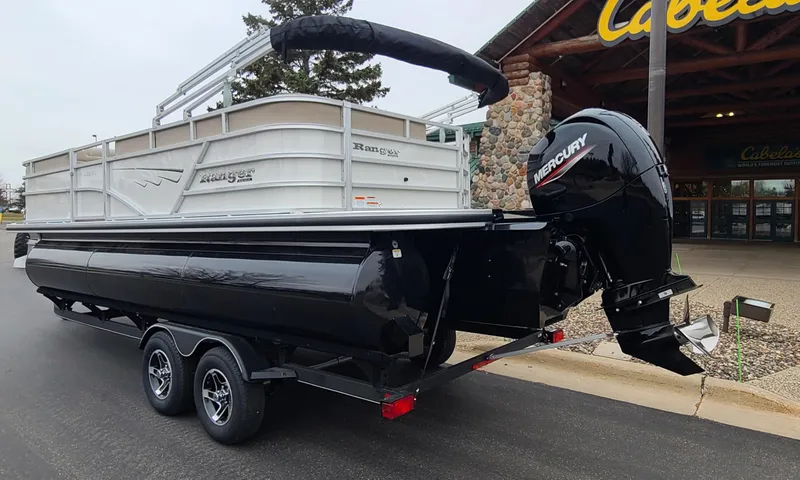 Slide: The Image of 2024 Ranger Reata 223C pontoon boat with Mercury outboard motor on trailer. - 2