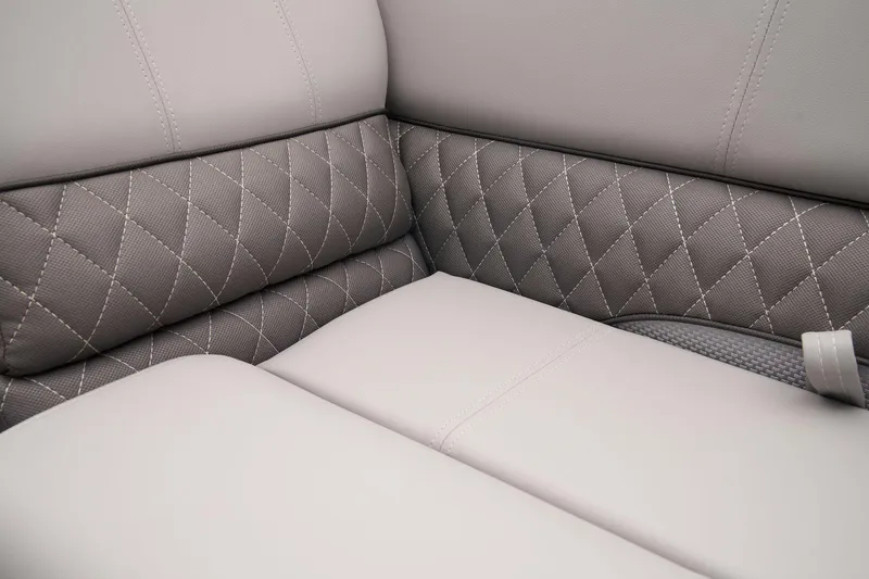 Slide: The Image of 2024 Ranger Reata 223C interior with diamond-stitched upholstery and light gray seating. - 27