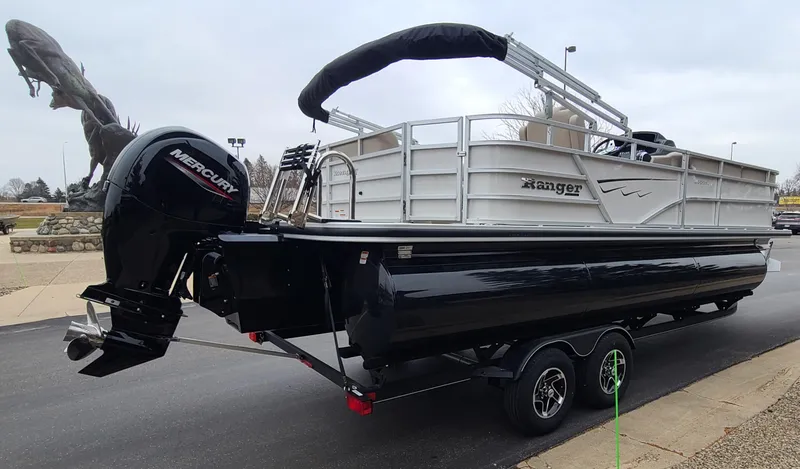Slide: The Image of 2024 Ranger Reata 223C pontoon boat on trailer with Mercury outboard motor. - 6