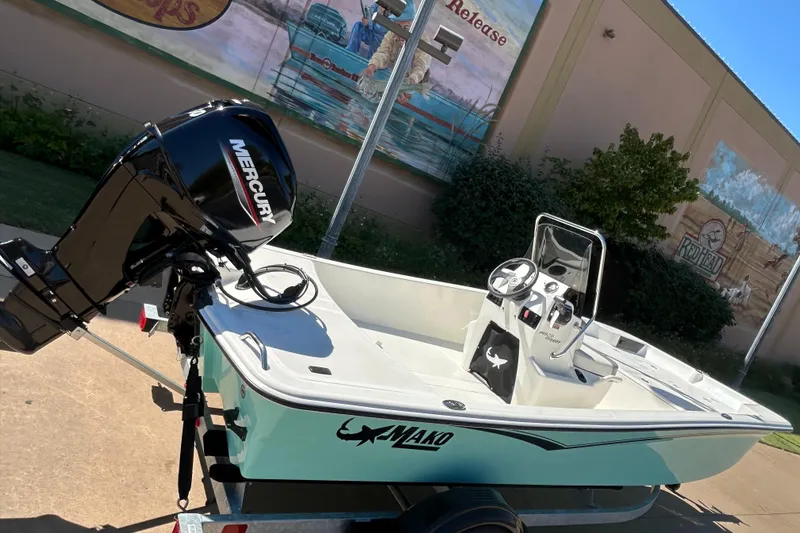 Slide: The Image of 2024 Mako Pro Skiff 15 CC boat with Mercury engine on trailer. - 2