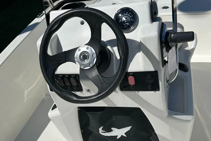 Slide: The Image of 2024 Mako Pro Skiff 15 CC steering console with controls and gauges. - 5