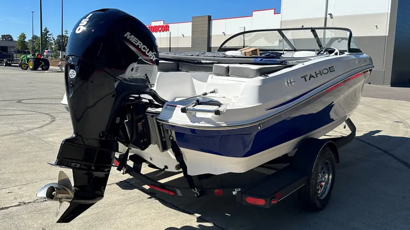 Slide: The Image of 2024 Tahoe 200 S boat with Mercury outboard motor in a parking lot. - 3