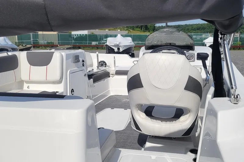 Slide: The Image of 2024 Tahoe 2150 boat interior with modern seating and steering console. - 3