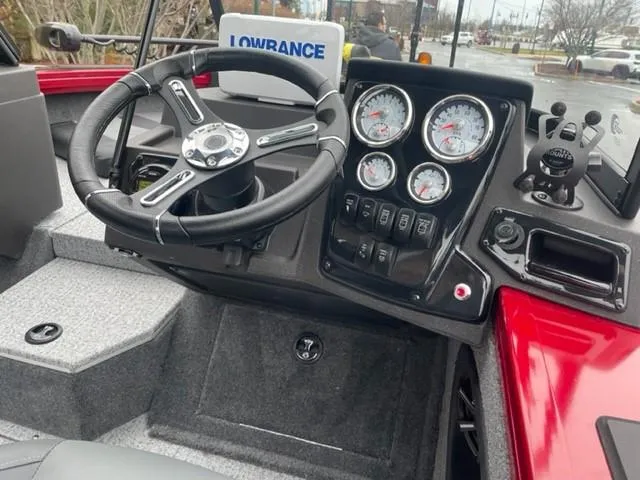 Slide: The Image of 2024 Tracker Targa V-18 Combo boat dashboard with steering wheel and gauges. - 2