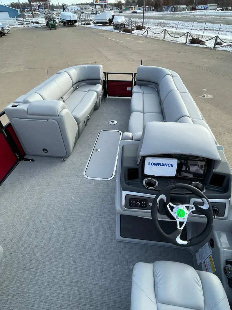 Slide: The Image of 2024 Regency 250 DL3 pontoon boat interior with plush seating and advanced navigation system. - 2