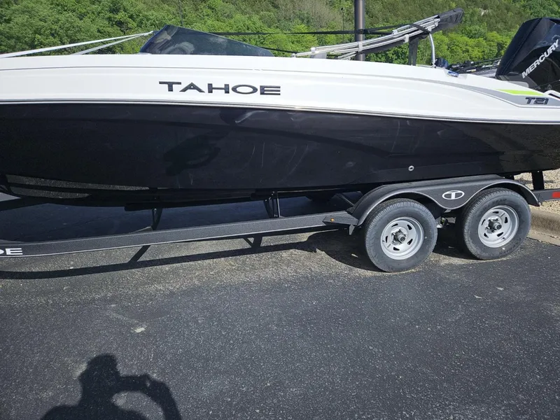 The Image of 2024 Tahoe T21 boat on a trailer in a parking lot. - 0