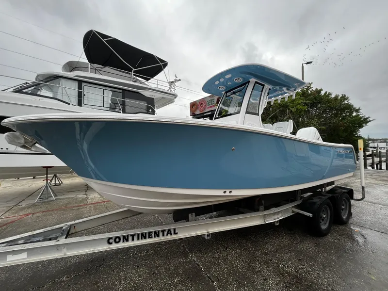 Slide: The Image of 2024 Sportsman Open 232 Center Console boat on Continental trailer. - 1