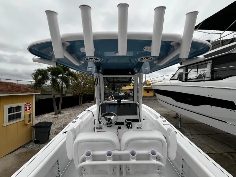 Slide: The Image of 2024 Sportsman Open 232 Center Console boat with rod holders and helm station. - 12