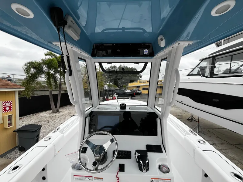 Slide: The Image of 2024 Sportsman Open 232 Center Console boat interior with steering wheel and control panel. - 13