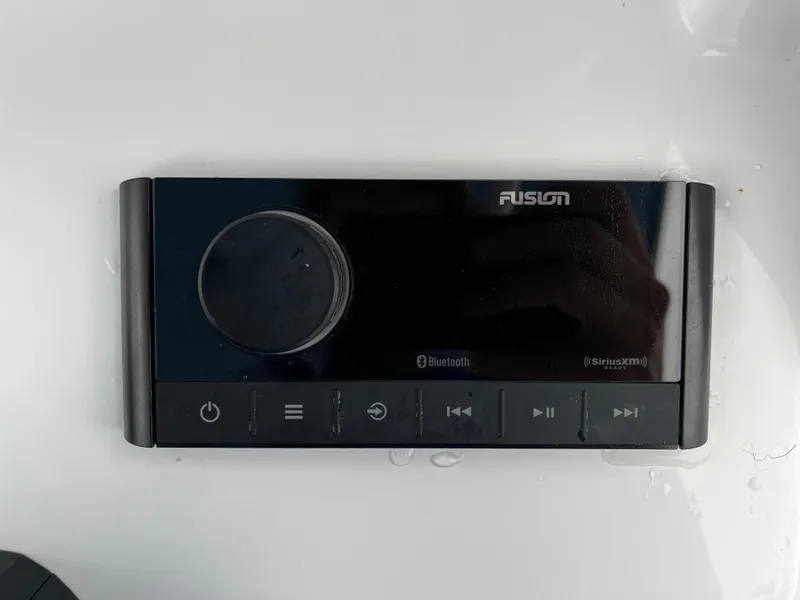 Slide: The Image of Fusion audio control panel on 2024 Sportsman Open 232 Center Console boat. - 16