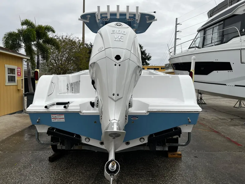 Slide: The Image of 2024 Sportsman Open 232 Center Console boat with Yamaha engine, rear view. - 4