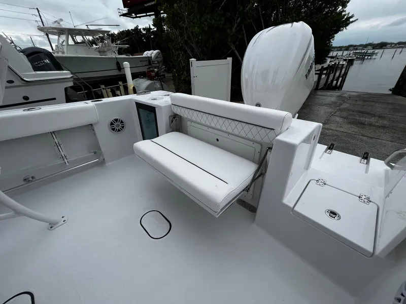 Slide: The Image of 2024 Sportsman Open 232 Center Console boat with foldable seating and clean deck. - 6