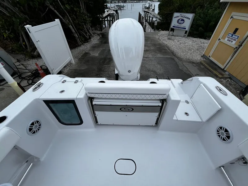 Slide: The Image of 2024 Sportsman Open 232 Center Console boat at dock, rear view. - 8