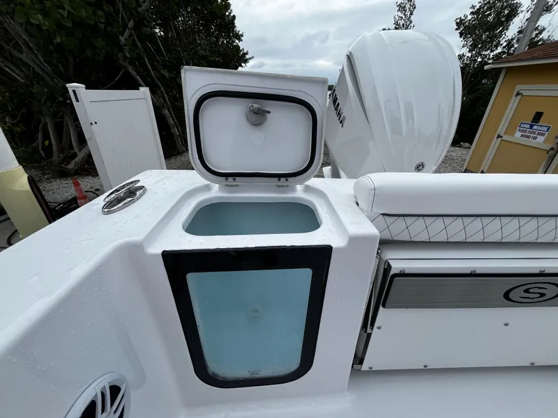 Slide: The Image of 2024 Sportsman Open 232 Center Console boat with open storage compartment. - 9