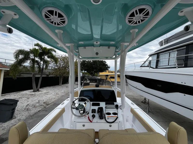 Slide: The Image of 2024 Sportsman Masters 227 Bay Boat interior with helm and seating. - 11