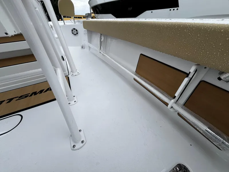 Slide: The Image of 2024 Sportsman Masters 227 Bay Boat interior deck with white and tan accents. - 16