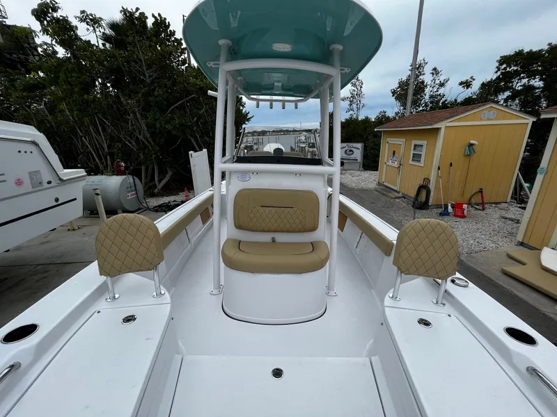 Slide: The Image of 2024 Sportsman Masters 227 Bay Boat with tan seating and white deck. - 20