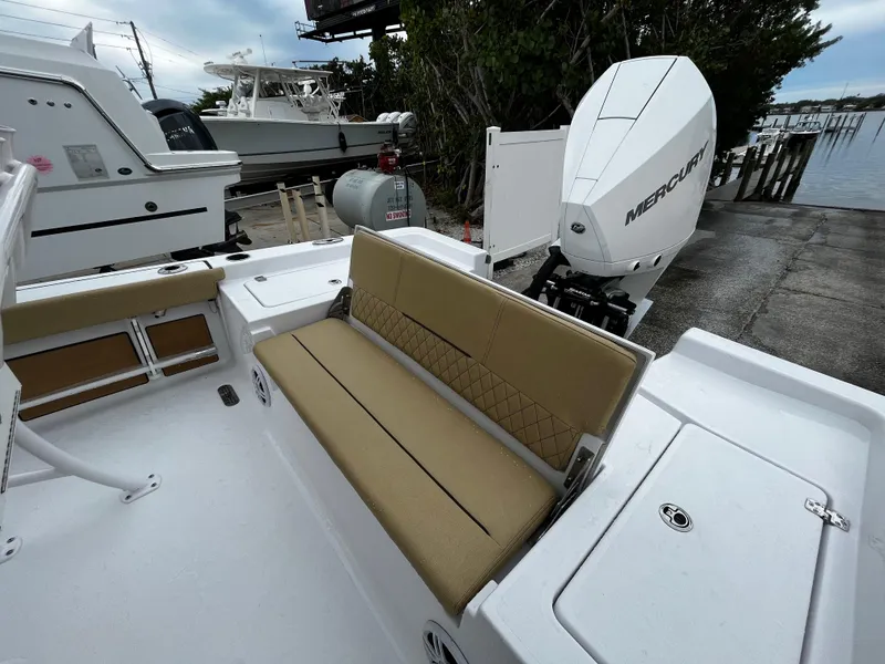 Slide: The Image of 2024 Sportsman Masters 227 Bay Boat with tan seating and Mercury outboard engine. - 7