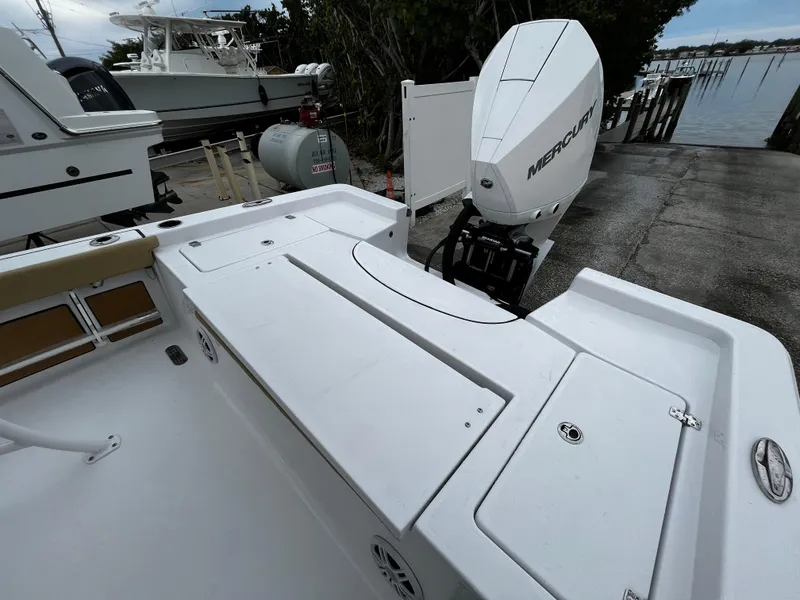 Slide: The Image of 2024 Sportsman Masters 227 Bay Boat with Mercury outboard engine at dock. - 8