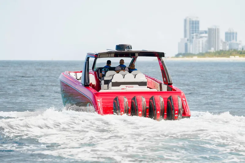 Slide: The Image of 2025 Cigarette 42 Auroris boat cruising on the water with city skyline in the background. - 2