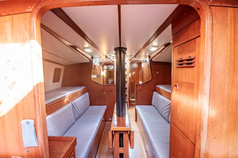Slide: The Image of Interior of a 1977 Baltic 42 sailboat with wooden finish and cozy seating. - 10