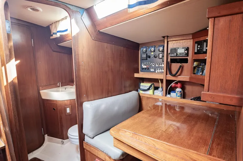 Slide: The Image of Interior of a 1977 Baltic 42 sailboat with wooden cabinetry and navigation station. - 13