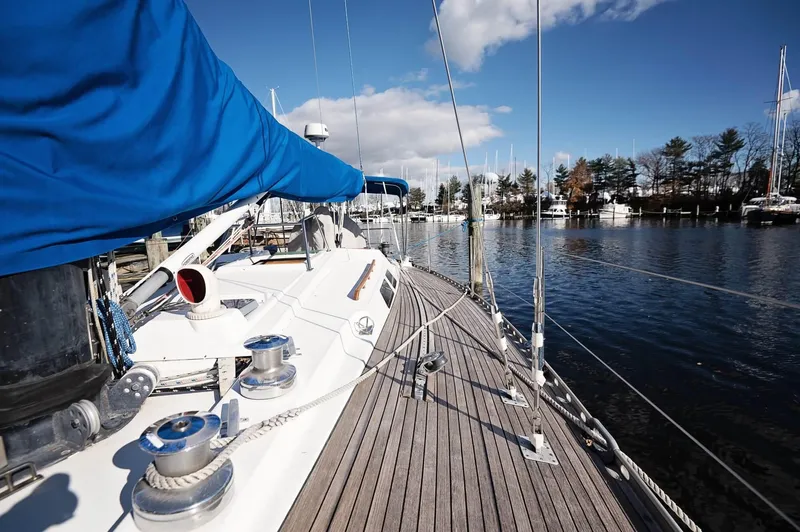 Slide: The Image of Sailboat Baltic 42 (1977) docked, featuring blue sail cover and wooden deck. - 25