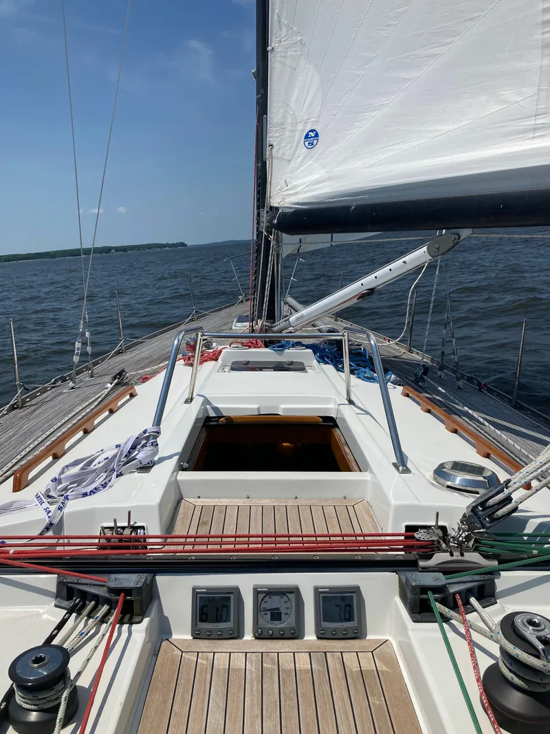 Slide: The Image of 1977 Baltic 42 sailboat on open water, showcasing deck and sails under clear skies. - 26