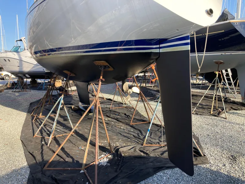 Slide: The Image of Baltic 42 sailboat from 1977 on stands, showcasing its sleek hull and keel design. - 28