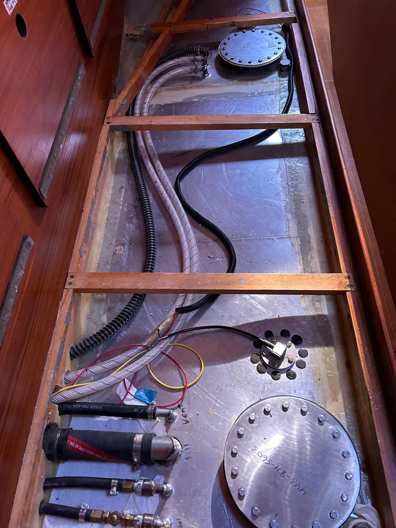 Slide: The Image of Interior view of a 1977 Baltic 42 yacht showing wiring and plumbing components. - 31