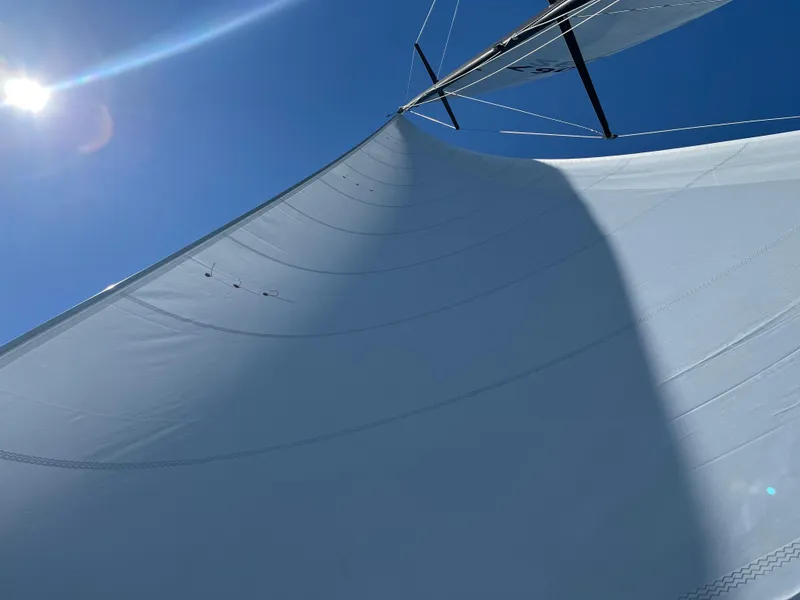 Slide: The Image of Sail of a 1977 Baltic 42 yacht against a clear blue sky. - 36