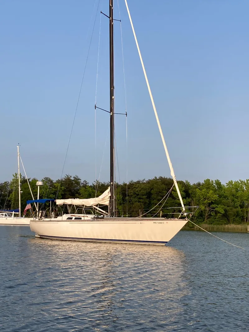 Slide: The Image of 1977 Baltic 42 sailboat anchored on calm water with clear blue sky. - 38