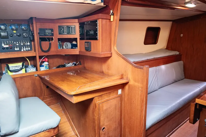 Slide: The Image of 1977 Baltic 42 yacht interior with navigation station and cozy seating area. - 5