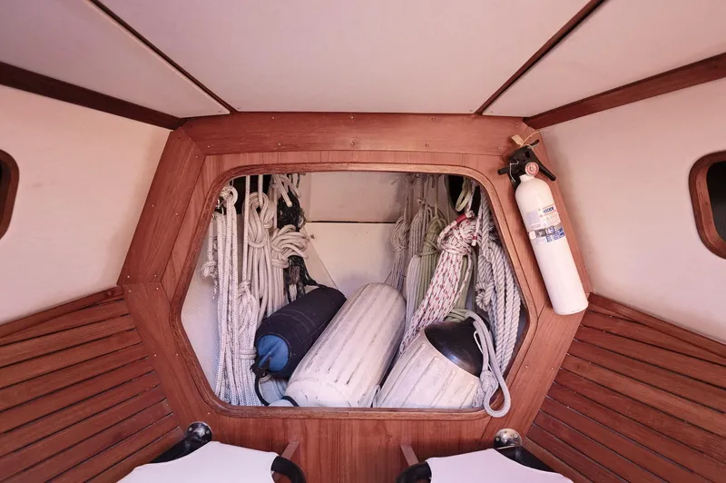 Slide: The Image of Interior of a 1977 Baltic 42 sailboat with ropes and fenders stored neatly. - 9