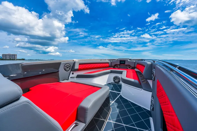 Slide: The Image of 2025 Cigarette 42 Nighteagle luxury boat interior with red and gray seating, ocean view. - 13