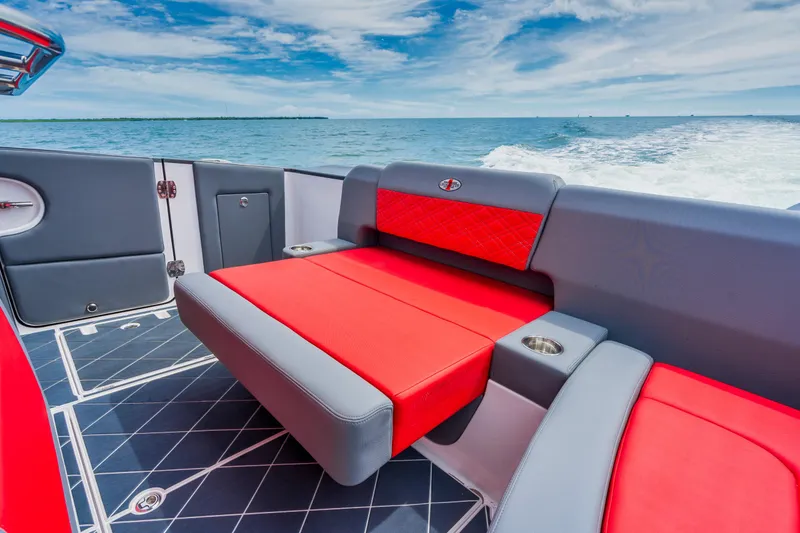 Slide: The Image of Cigarette 42 Nighteagle 2025 boat with red and gray seating on open water. - 16