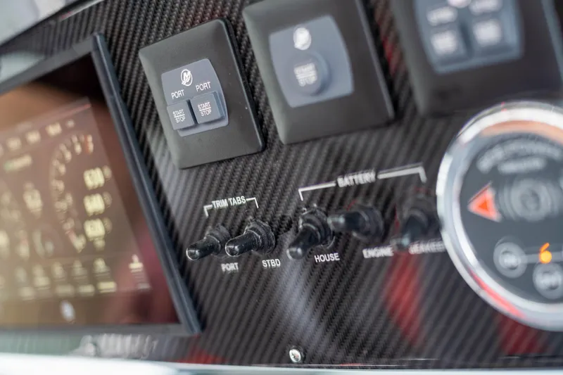 Slide: The Image of Control panel of 2025 Cigarette 42 Nighteagle boat with trim tabs and battery switches. - 24