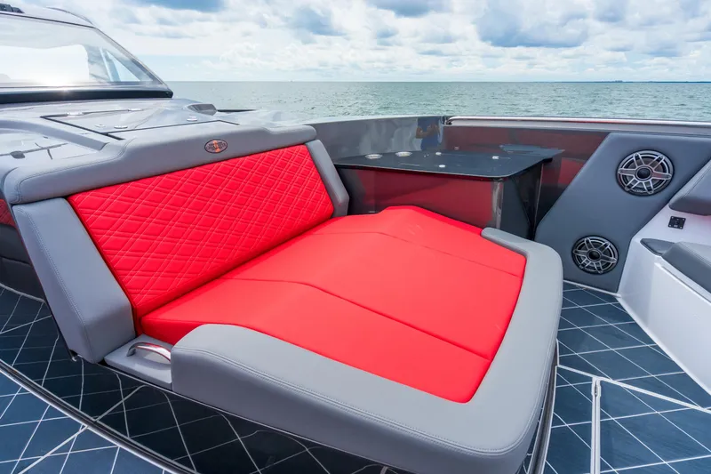 Slide: The Image of Luxury seating on 2025 Cigarette 42 Nighteagle boat with red and gray upholstery. - 27