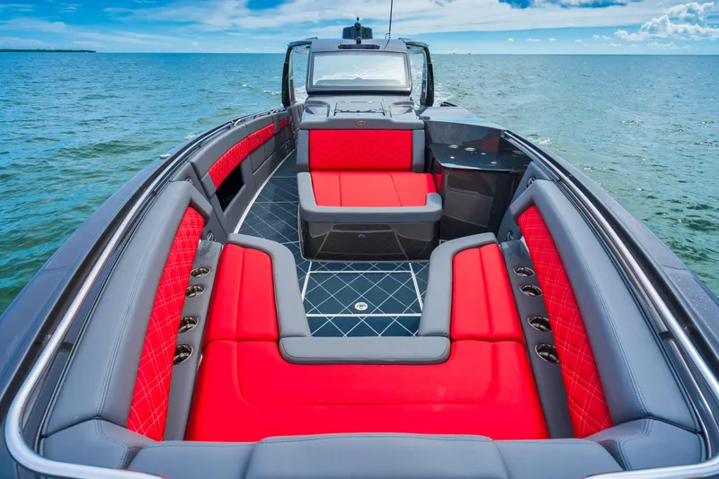 Slide: The Image of 2025 Cigarette 42 Nighteagle boat with red and gray seating on open water. - 28
