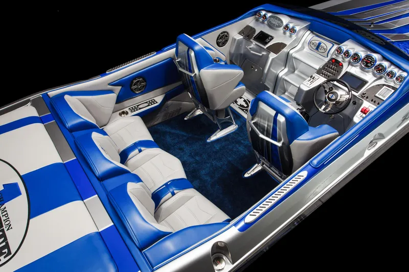 Slide: The Image of 2025 Cigarette 38 Top Gun boat interior with blue and white seating and advanced dashboard. - 16