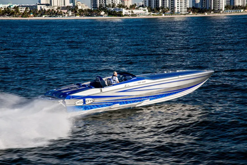 Slide: The Image of 2025 Cigarette 38 Top Gun speedboat cruising on the water near a city skyline. - 8
