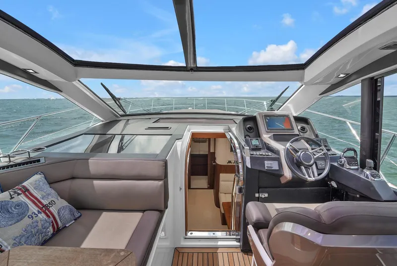 Slide: The Image of 2017 Galeon 445 HTS yacht interior with helm and seating area. - 12
