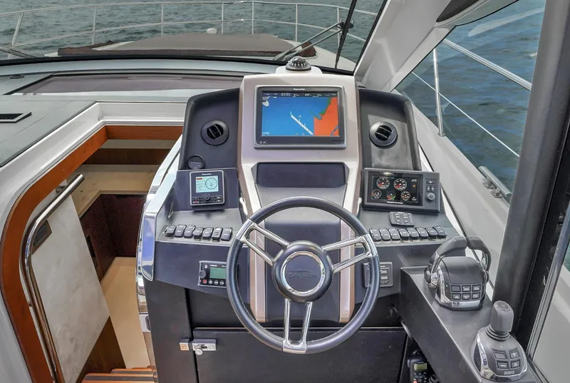Slide: The Image of 2017 Galeon 445 HTS yacht helm with navigation screens and controls. - 16