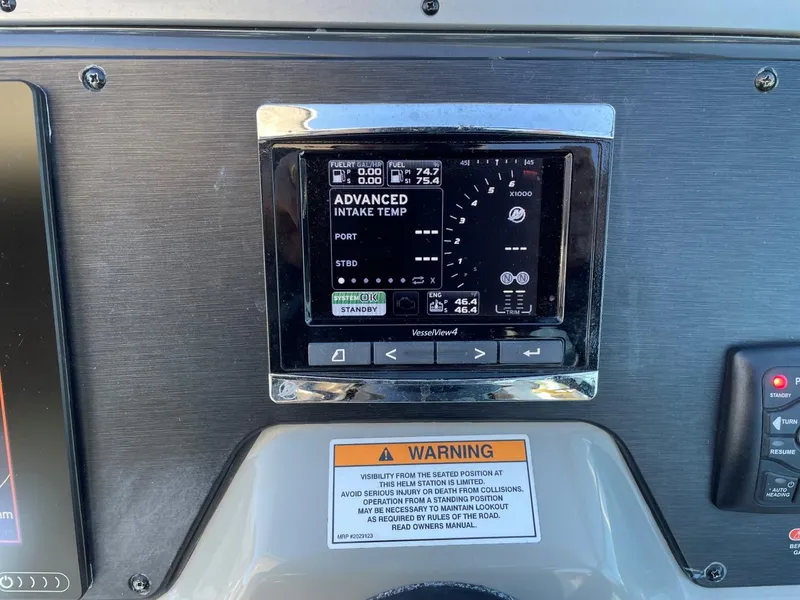 Slide: The Image of 2015 Sea Ray 370 Venture dashboard with VesselView display and warning label. - 18