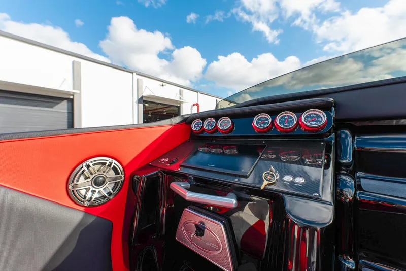 Slide: The Image of Dashboard of 2025 Cigarette 42X boat with gauges and controls under a blue sky. - 15